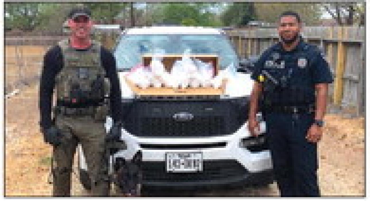 Sgt. Randy Thumann and Schulenburg Police Officer Byron Powe pose with the meth seized Wednesday.