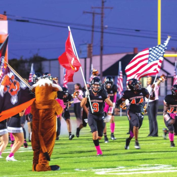 The Shorthorns run out on the field prior to Friday’s game. Photo by Andy Behlen