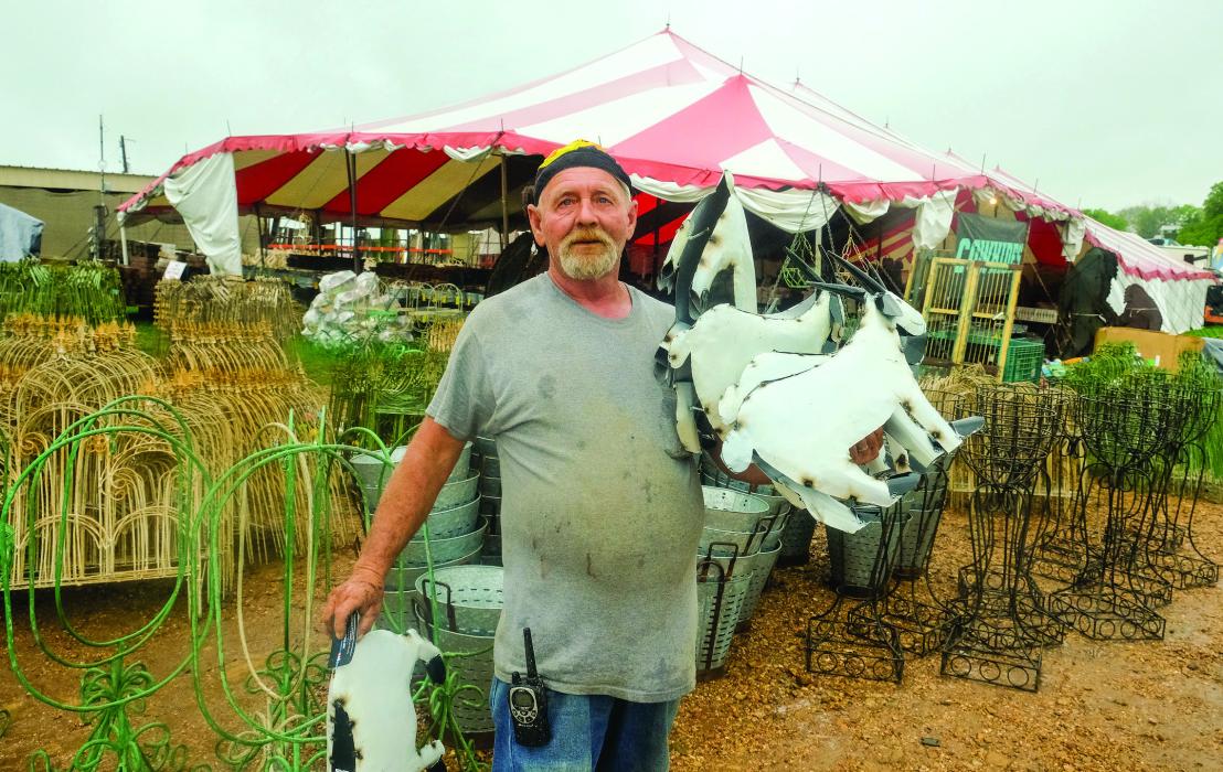 Vendor Larry Rush of Canton was busy restocking metal yard art goats at his tent in the Bar W Field in Warrenton Wednesday. Rush said the show has made a good comeback from the lean years of COVID-19.