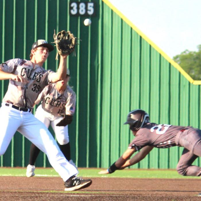 Fayetteville’s Brody Dooley slides into second and steals a base as RT-C’s Hunter Schobel makes a catch on the throw.