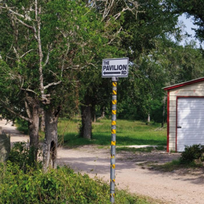 A sign off Munke Rd. near Cozy Corner marks the narrow private driveway leading to The Pavilion, a venue that hosted a trail ride last weekend, which ended in a deadly shooting. Photo by Andy Behlen