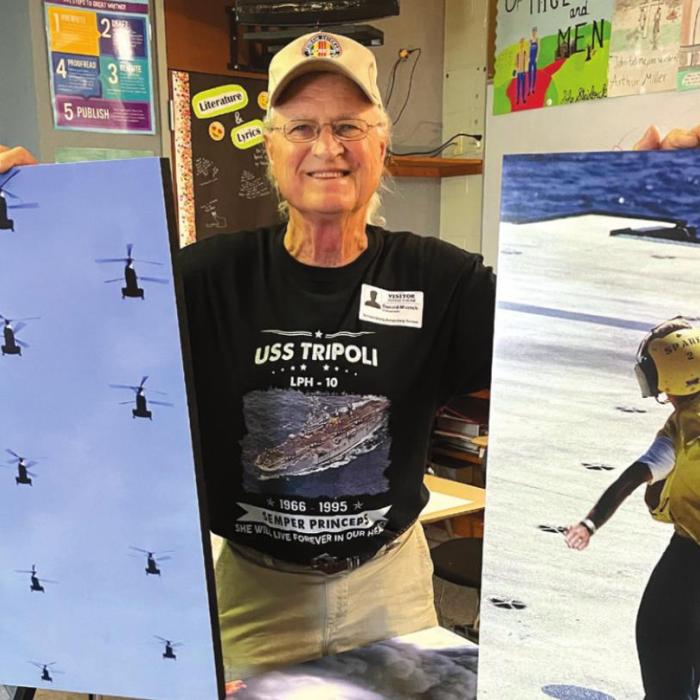 Vietnam Veterans of America No. 870 member Donald Mazoch, a photographer during the war, makes reference to a flight of 13 helicopters above the USD Tripoli. The other photo, a signalman on deck directing an aircraft landing.