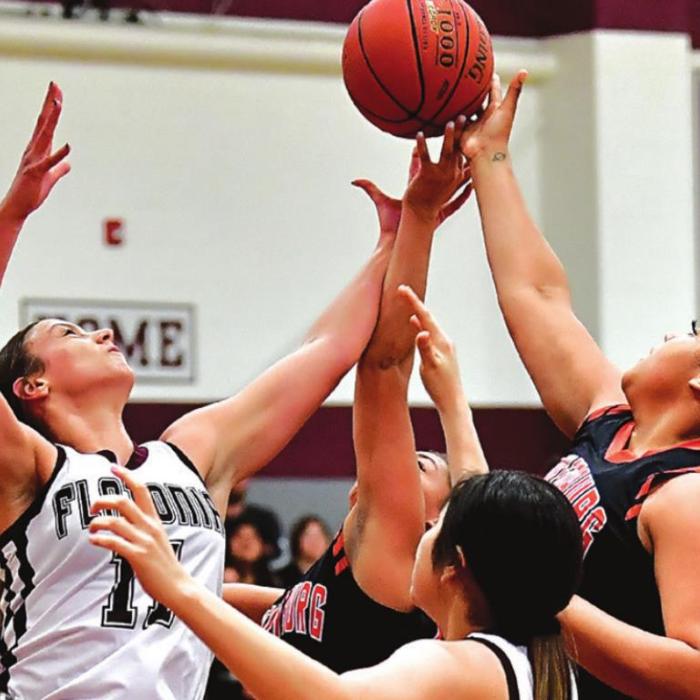 Flatonia’s Ellie Fike, left, battles for a rebound against a pair of Schulenburg players Tuesday. Photo by Stephanie Steinhauser