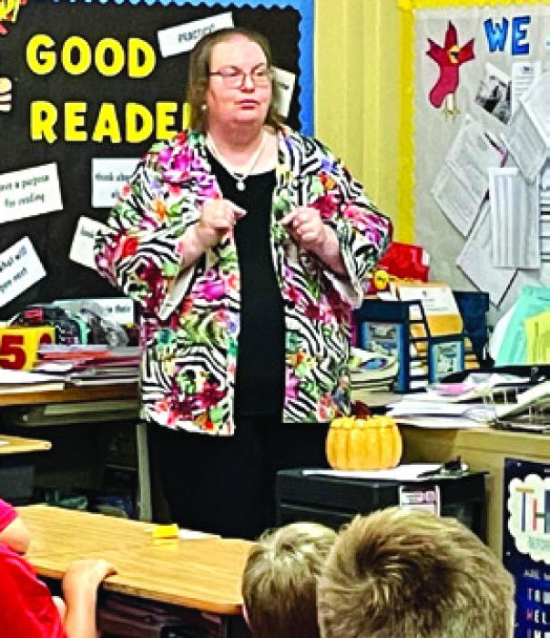 Peggy Supak speaks at a school event at St. Rose.