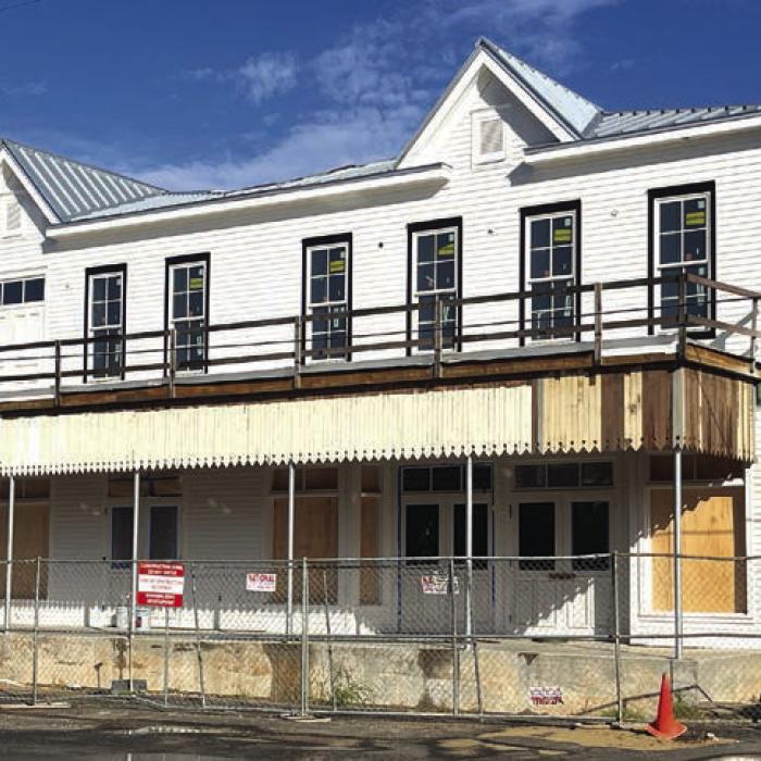 The new Fayetteville Community Center on the town square is really coming along. Above is how it looked Tuesday morning. The new building is modeled after the old Knesek building which stood on the site (below, left). The new facility uses as much of the old material from the building as they could salvage. Below, right – a show of just how far the construction has come since the slab was poured last August.