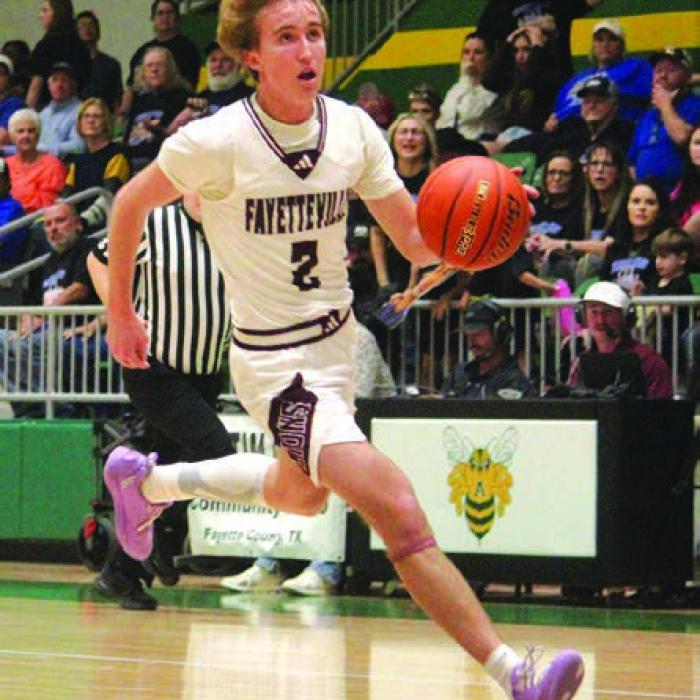Fayetteville’s Kole Schmitt leads a fast break Monday. He led the team in scoring with 20 points. Photo by Jeff Wick