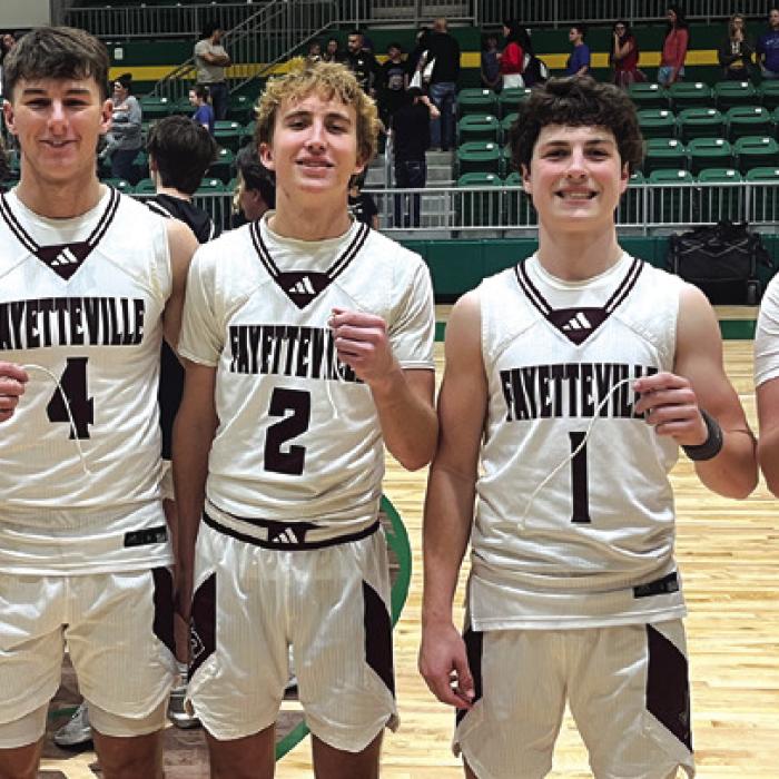 The senior members of the Fayetteville boys basketball team all hold up a piece of the net they cut down after Monday’s state semifinal victory. Left to right, Cole Jurecka, Jack Schley, Kole Schmitt, Mason Fenhaus and Kasen Kocian. Photo by Jeff Wick