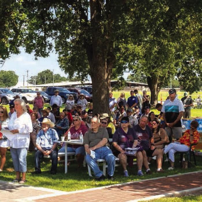 A large crowd gathered under the oak trees for the opening ceremony at the Slavnost celebration.