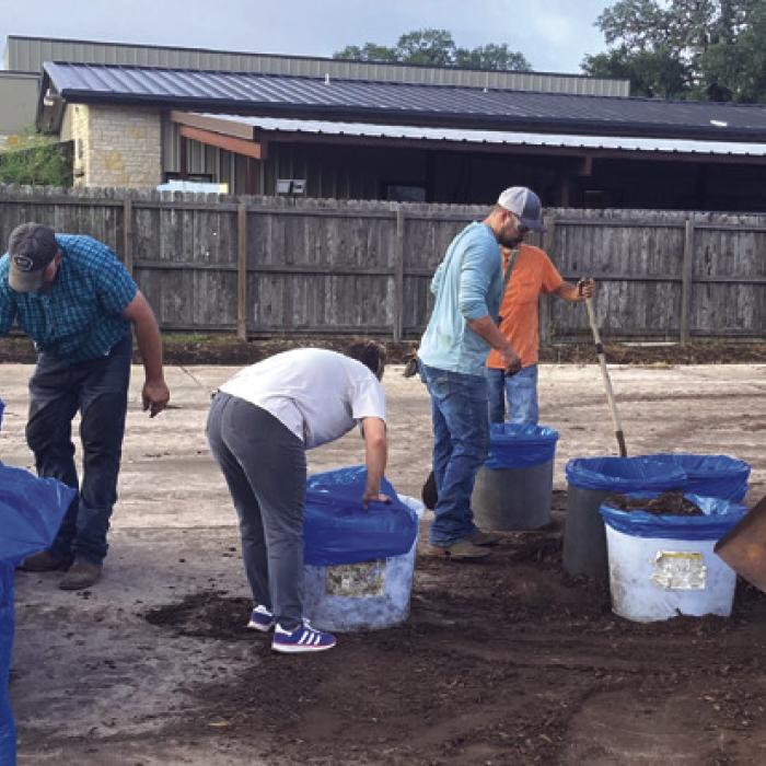 Volunteers bag up mulch to be given with each Liberty Tree. The mulch will be in blue county recycling bags and recipients can use the bags to bring trash back to the recycle center. The project paid the county for the bags, so no taxpayer money is involved.