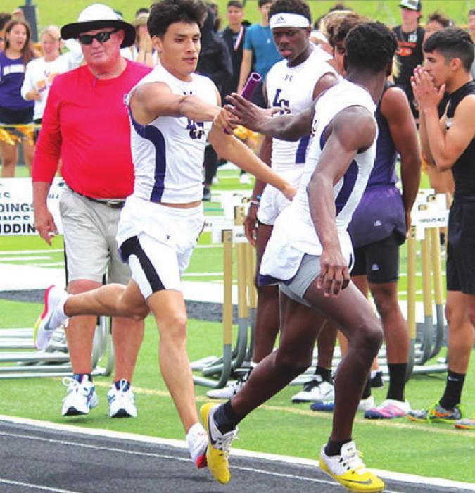 La Grange’s Gerald Rodriguez hands off to CJ Davis during La Grange’s 4x400 relay, which they ended up winning. Photo by Jeff Wick
