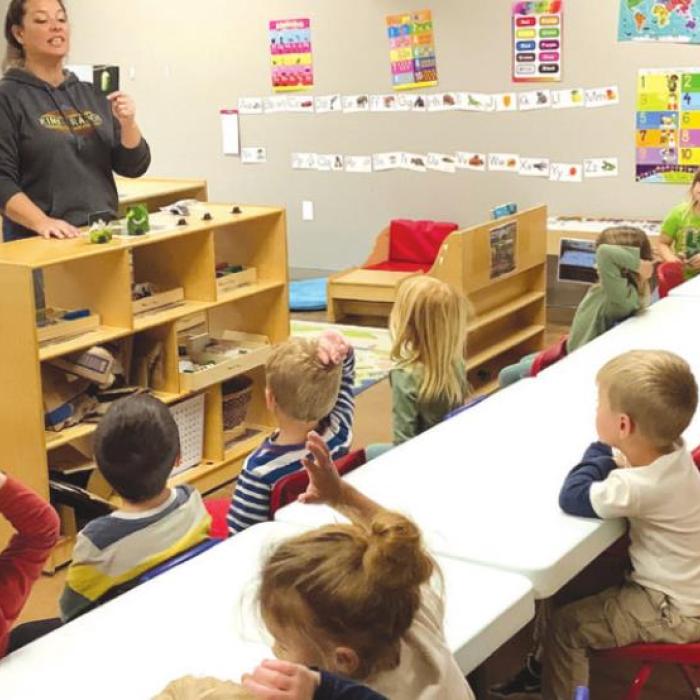 Remnant Acadamy students listen to teacher Thrina McCarty regarding the egg hatching process.