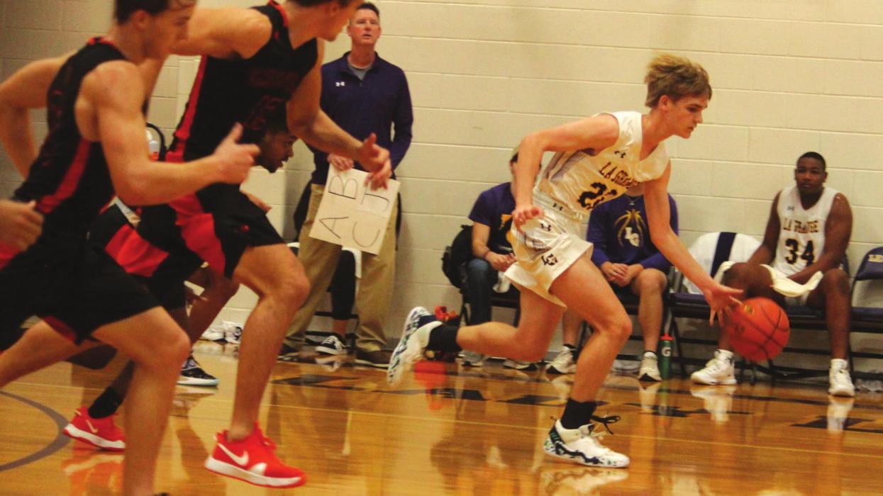 La Grange’s Ty Trlicek leads a fast break Friday as several Tigers try to catch up.