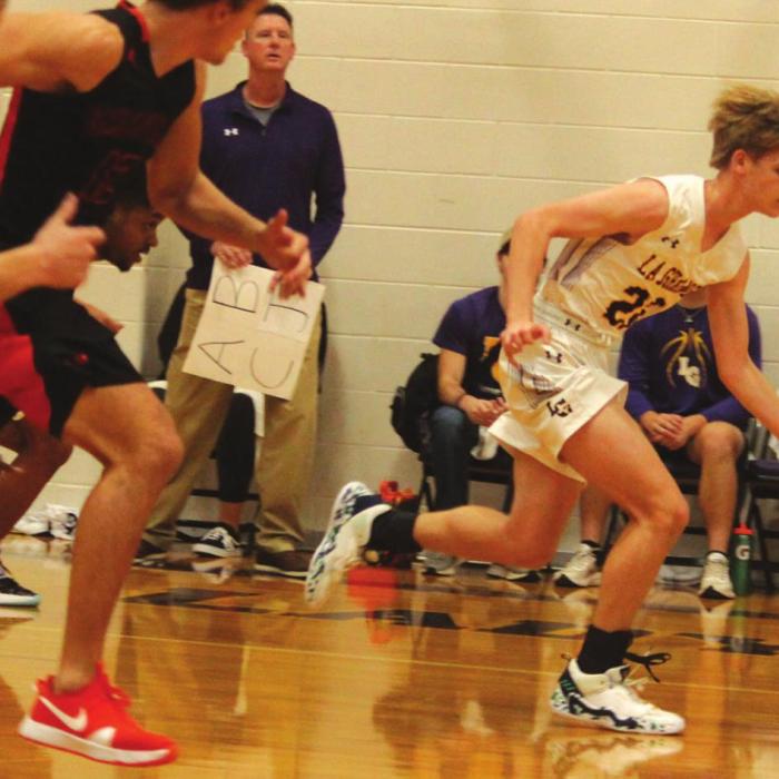 La Grange’s Ty Trlicek leads a fast break Friday as several Tigers try to catch up.