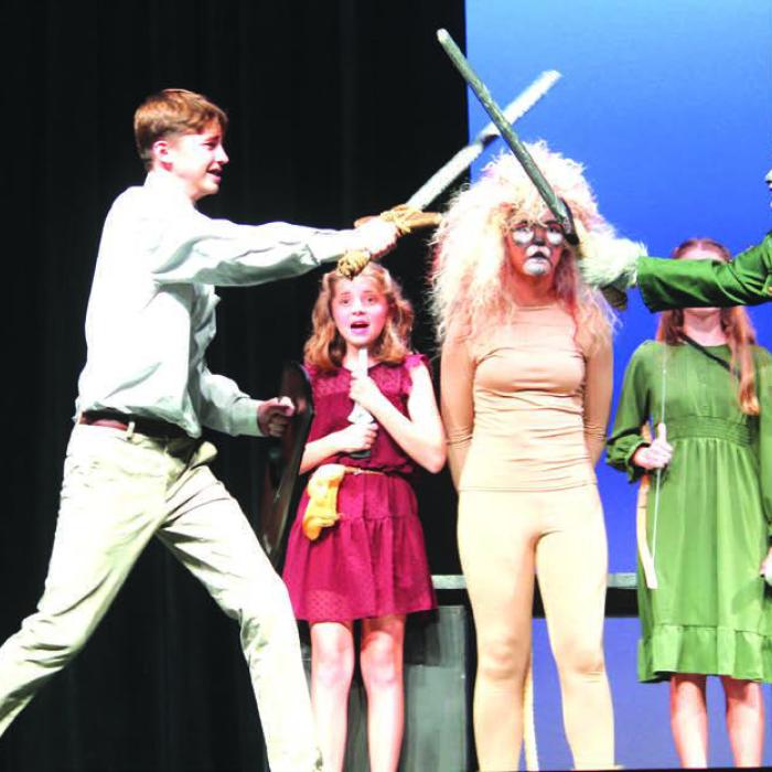 Deacon Wick (Peter) fights Hanna Garza (Fenris Ulf) as other cast members look on.