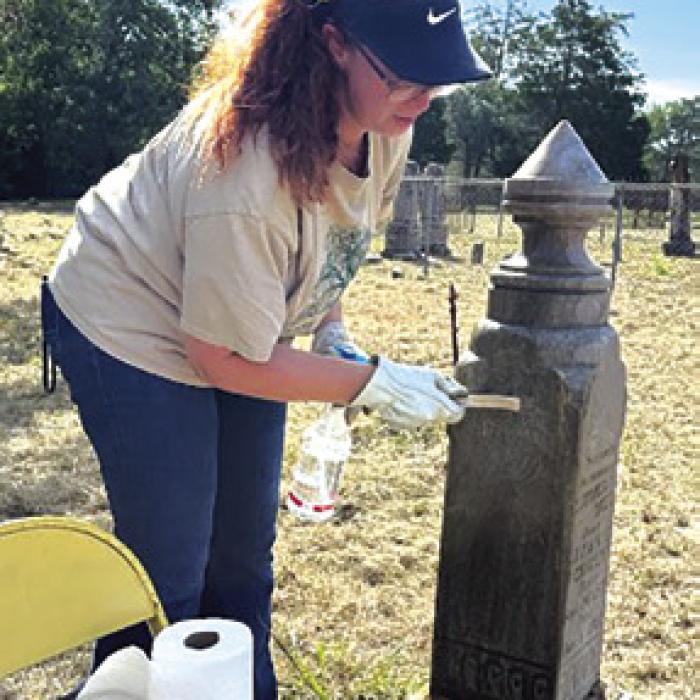 Victoria Russell cleaning Vana’s tombstone.