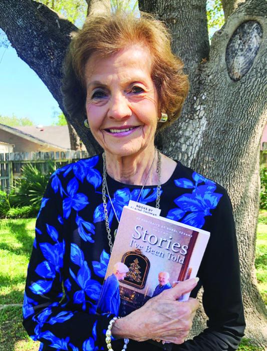 Marge Rosenberg holding an advance copy of the book she is featured in.