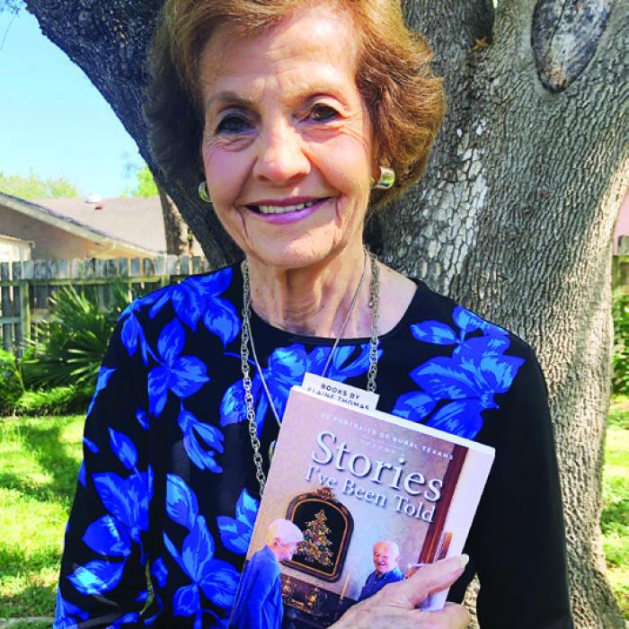 Marge Rosenberg holding an advance copy of the book she is featured in.