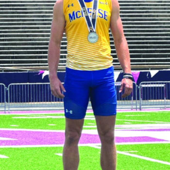 Lawson Fritsch on the podium at the conference meet getting his silver medal.