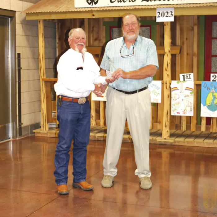 Glen Minzenmeyer receives his 2022 Hugh Hammond Bennett Regional Conservation Planner of the Year Award at the Area 3 Conservation Awards Banquet from Rick Schilling, State Area 3 board member on the Association of Texas Soil and Water Conservation District.