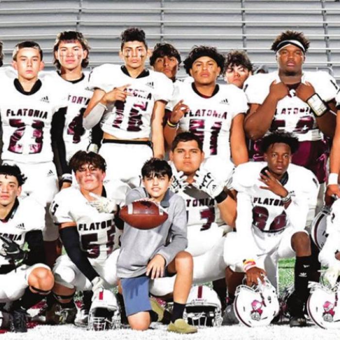 The Flatonia Bulldogs pose on the field after Friday’s victory over Johnson City in San Antonio. Photo by Stephanie Steinhauser