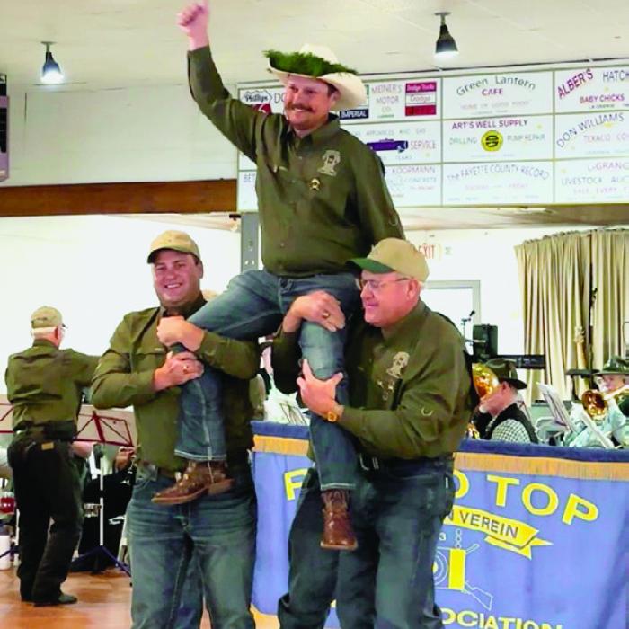 Cullen and Dave Weishuhn carried the new Schützenkönig, Judson Limmer, at the Round Top Schützenfest on Sept. 21