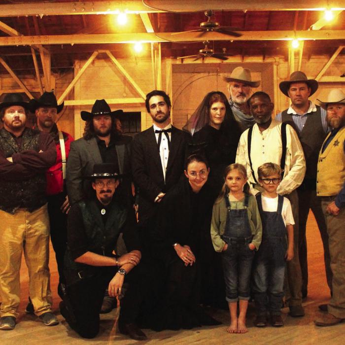 Cast members of “The Man Who Shot Liberty Valance” which will be shown at the Fair Pavilion in La Grange this weekend. Left to right: Front row – Garrett Reavis, Emily Hudson, Lucy Martin, Judah Martin; Back row: Layelah Martin, Will Martin (assistant director), Brandon Theut, Kyle Hartmann (director), Austin Williams, Caleb Parks, Melanie Lira, Doug Forrest, Gregory Rhodes, Jeff Wick, Judd Ulrich, Steve Wynne.