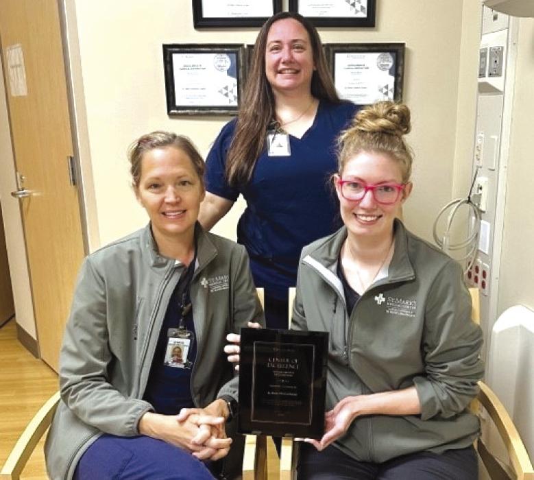 St. Mark’s Advanced Outpatient Wound Center team, front from left: Stacie Schramek, RN, and Jackie Faigle, FNP-C; back row, Jennifer Scott, RN, Program Director, with the team’s Restorix-Health Clinical Distinction Award. The team is one of only 26 in the US to achieve the goals in wound healing rates and safety.
