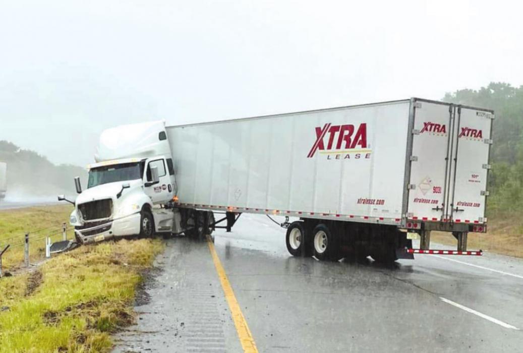 Wet conditions contributed to a number of traffic accidents around teh County on Monday, including this 18-wheeler that jackknifed on Interstate 10 near Schulenburg. Photo courtesy of the Fayette County Sheriff’s Office