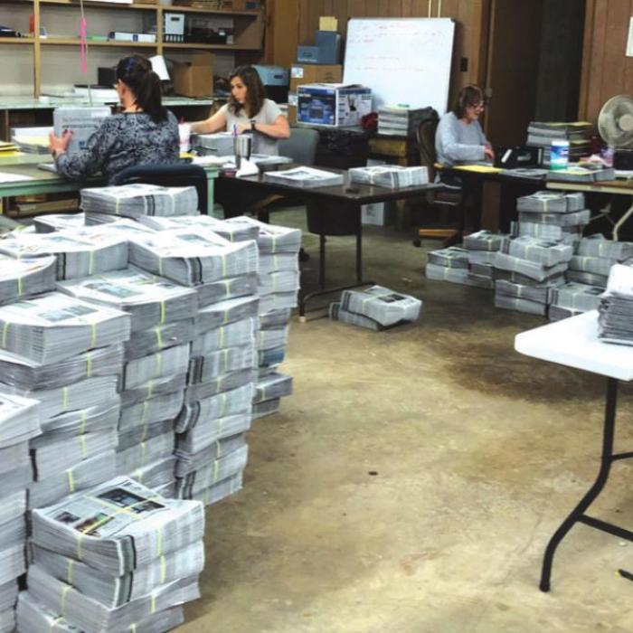 The back half of our office is packed with bundles of newspapers getting prepped for delivery every Monday and Thursday.