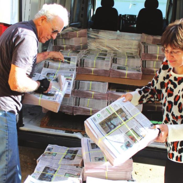 George Kana and Jessica Montez unload a delivery van with 6,000 copies of The Fayette County Record earlier this month. Photos by Jeff Wick