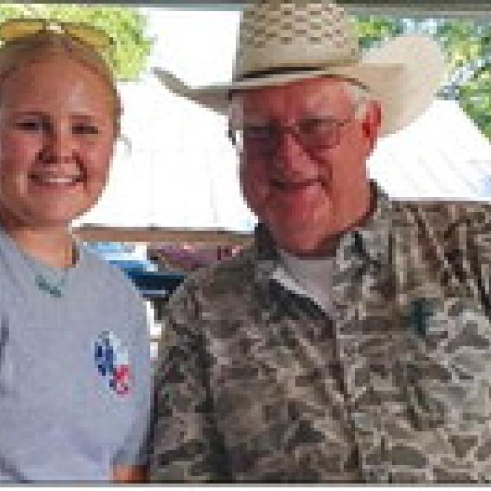 Addison Fryer, live auction volunteer, and Lee Fritsch, Auctioneer.