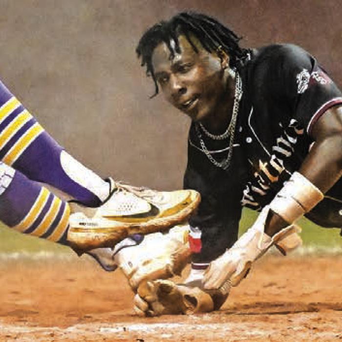Flatonia’s Keyshaun Green, right, stole home on a passed ball amidst a tangle at the plate Tuesday. But that was the only run the Bulldogs scored in what ended up being a 2-1 extra-inning loss to Shiner in a game that decided the district title. Flatonia (17-4) begin the playoffs next week as the runner-up from District 29-2A. Photo by Stephanie Steinhauser