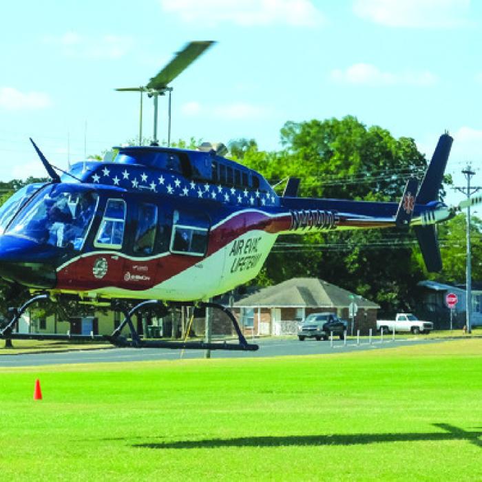 A helicopter from Air Evac Lifeteam departs a landing zone at the La Grange High School practice field last October to transport a man who suffered medical emergency. Air Evac closed its base in La Grange last week. Record File Photo