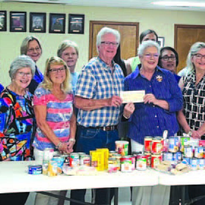 Presenting a monetary donation and other items for AMEN were the members of Court Annunciation No. 1962 and Regent Sherry Hebert to AMEN Food Pantry representative Mark Hebert.