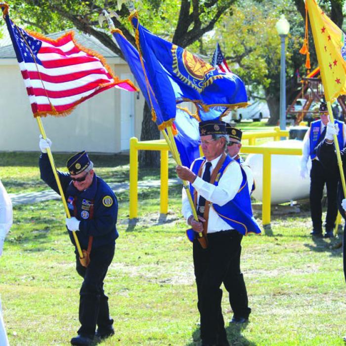Sunday’s windy conditions made bringing in the flags a strenuous job.