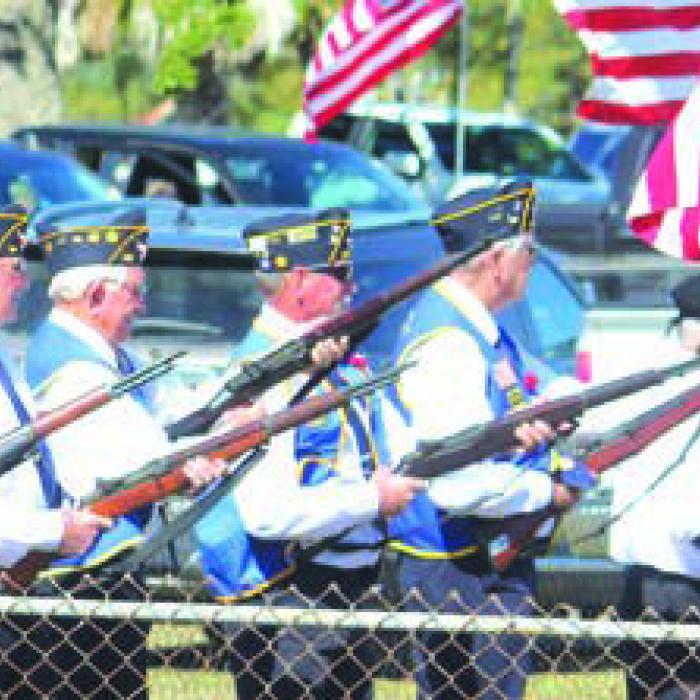 A firing squad shot off a triple volley salute during Sunday’s ceremony.