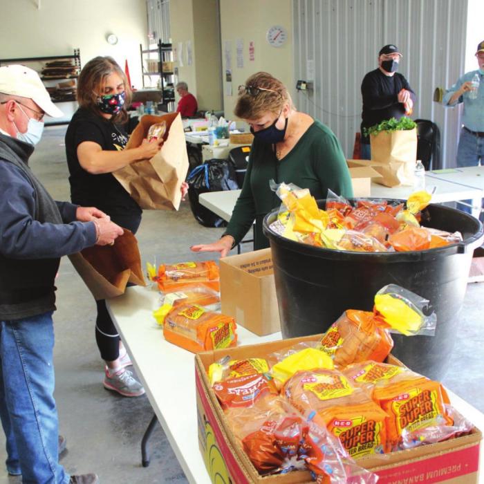 AMEN Food pantry volunteers wrap up some final chores after a morning full of distributing food last Monday in La Grange. Photo by Jeff Wick