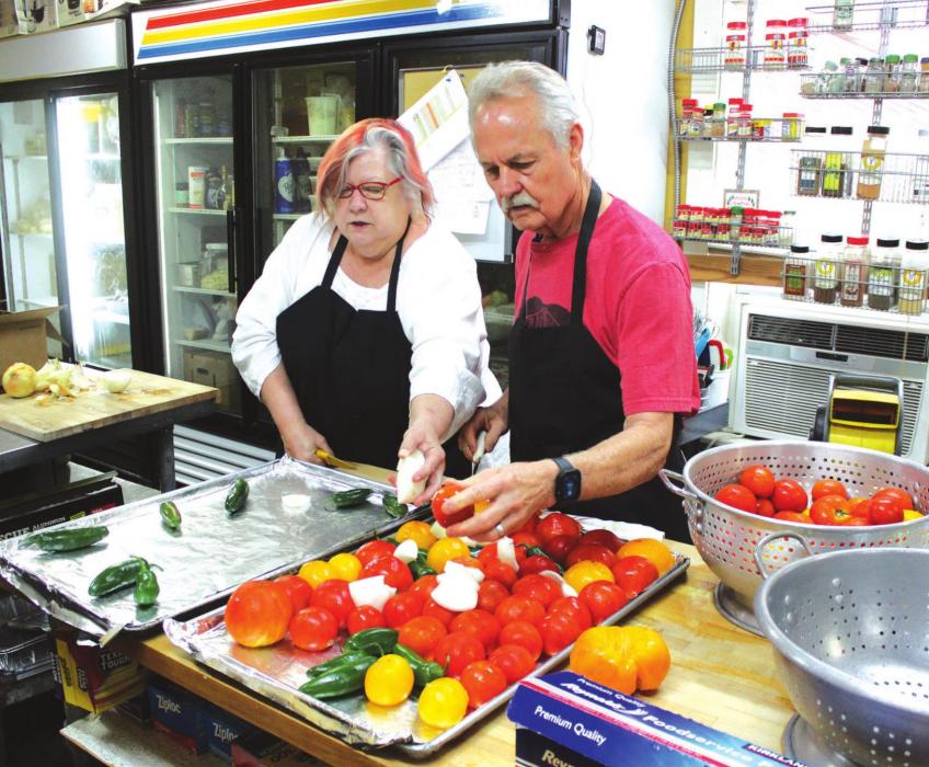 Susan Kuehler and Mike McCathern, the wife and husband co-owners of Bistro 108 and Celebrations in downtown La Grange work together to chop up local produce for a salsa that was part of one of their Saturday Supper Club events, a reinvention of their former restaurant roles.Photos by Jeff Wick