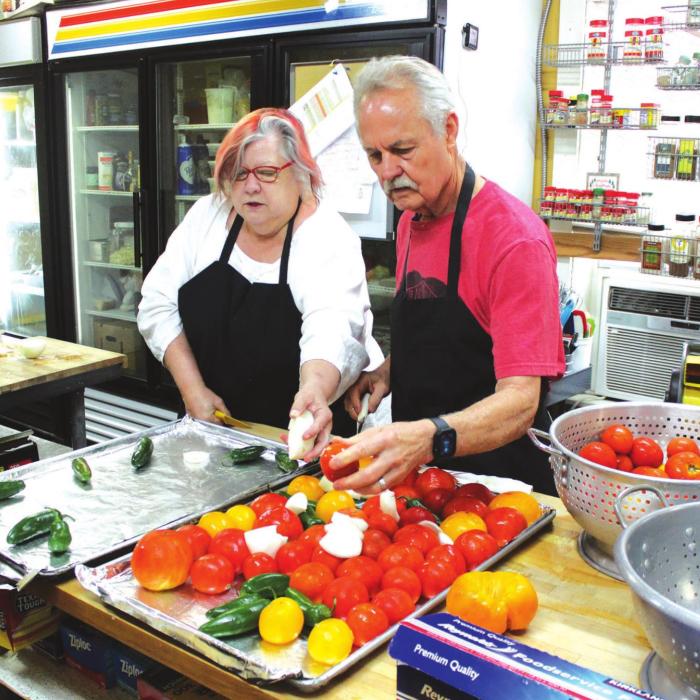Susan Kuehler and Mike McCathern, the wife and husband co-owners of Bistro 108 and Celebrations in downtown La Grange work together to chop up local produce for a salsa that was part of one of their Saturday Supper Club events, a reinvention of their former restaurant roles.Photos by Jeff Wick