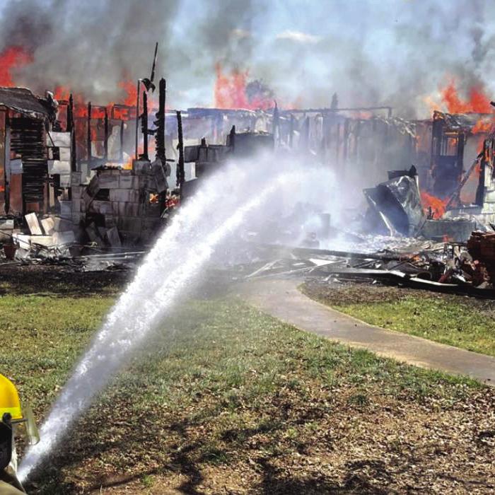 Ledbetter firefighters battle a house fire in April. The department celebrates this 75th anniversary this weekend. Record file photo