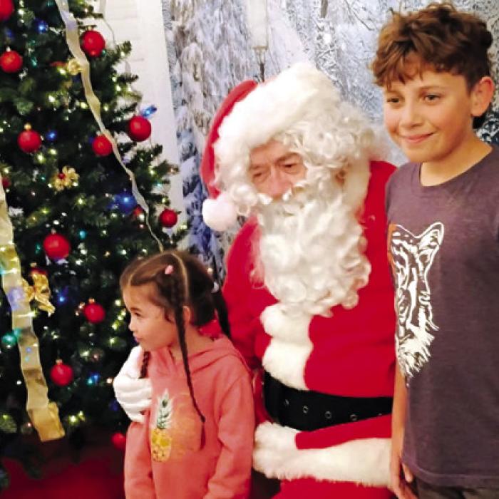 Santa hearing the hopes for Christmas gifts.