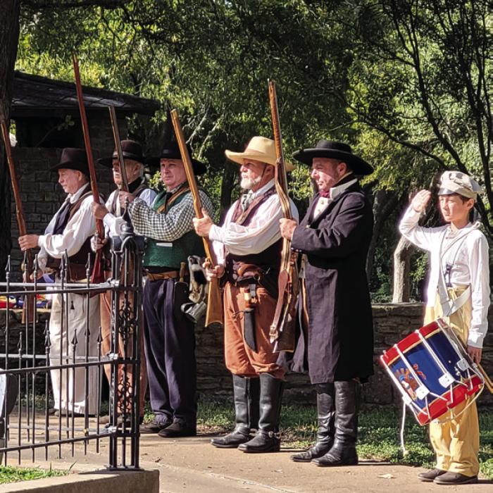 Texian reenactors line up to march to the bluff for the gun salute.