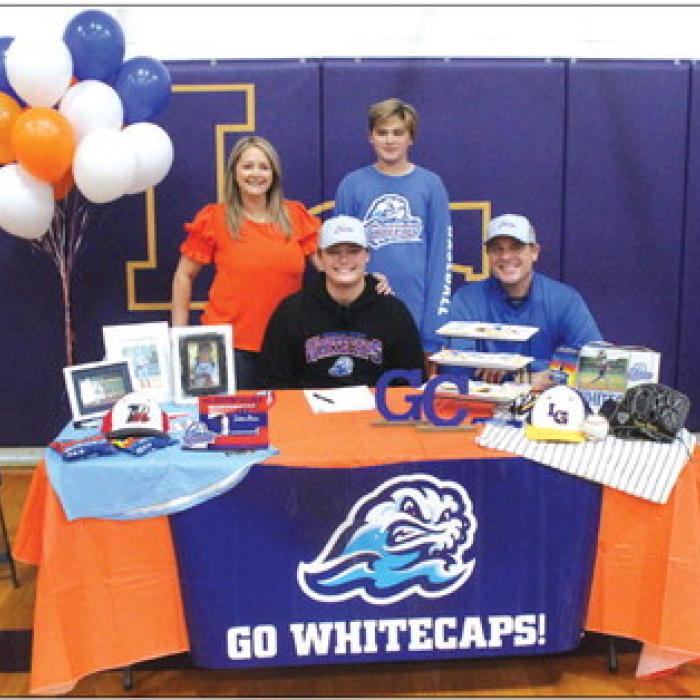 La Grange ace senior pitcher Trenton Barnes signed a scholarship agreement Friday to play for Galveston College after graduation. He is shown here at his signing ceremony seated, center, with his dad Bret beside him. Standing are Trenton’s mom Sarah and brother Korbin. Photo by Jeff Wick