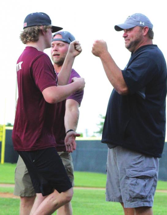 Josh Vitek, right, greets his son Parker, left, during a pep rally for the Fayetteville baseball team last Monday. Photo by Lacey Vitek
