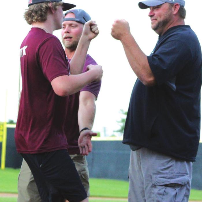 Josh Vitek, right, greets his son Parker, left, during a pep rally for the Fayetteville baseball team last Monday. Photo by Lacey Vitek