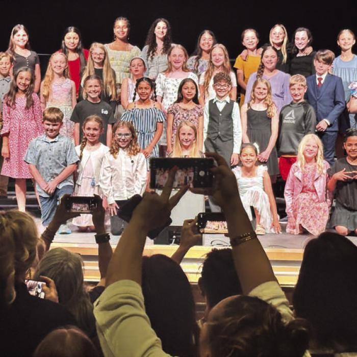 The La Grange elementary school honor choir held their public performance last Tuesday at the Performing Arts Center. Here the choir and director Phillip Brummett pose for pictures after the show. Photo by Chrystal Wick