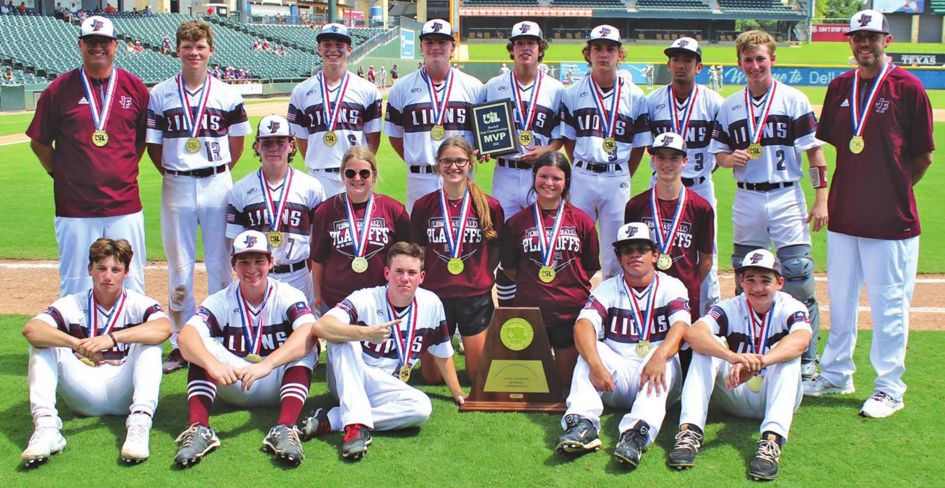 The Fayetteville Lions pose with their state title trophy and their state gold medals on the Dell Diamond field after winning the 1A title by defeating Kennard 6-4. Photo by Jeff Wick