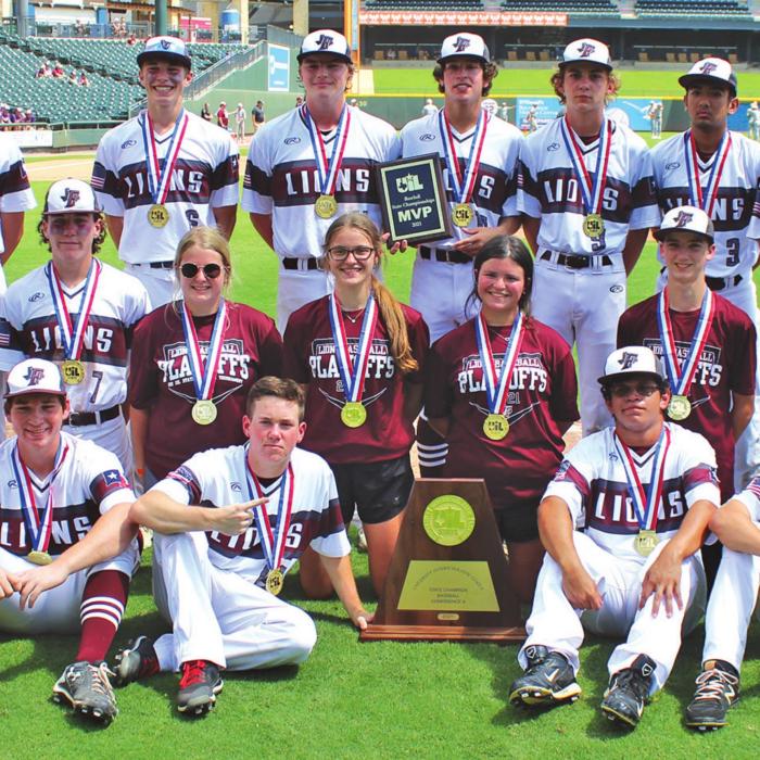 The Fayetteville Lions pose with their state title trophy and their state gold medals on the Dell Diamond field after winning the 1A title by defeating Kennard 6-4. Photo by Jeff Wick