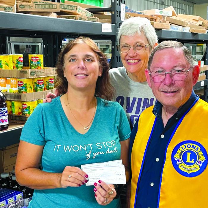 The La Grange Noon Lions Club recently gathered donations from the Lee County Sheriff’s Office, the Fayette County Sheriff’s Office, members of the Noon Club and matching funds from the La Grange Lions Foundation for the AMEN Food Pantry. Lion Treasurer Chuck Gibson is shown presenting donations totaling $2,200 to Cassie Girard and Susan Schultz of AMEN.