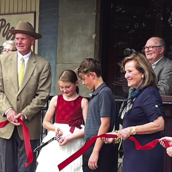 Diane Mikesky and Nina Howard of the Schulenburg Chamber of Commerce assisted Katrina Elvig’s grandchildren, Jaxson and Josie Packard, in cutting the ribbon at the ceremony to unveil a historical marker from the Texas Historical Commission on the Breymann Building.